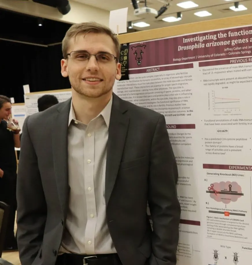 jeffrey callan standing in front of his 2019 Mountain Lion Research Day poster board